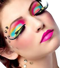 beauty and cosmetics - woman with bold vibrant colored eye shadows and lipstick